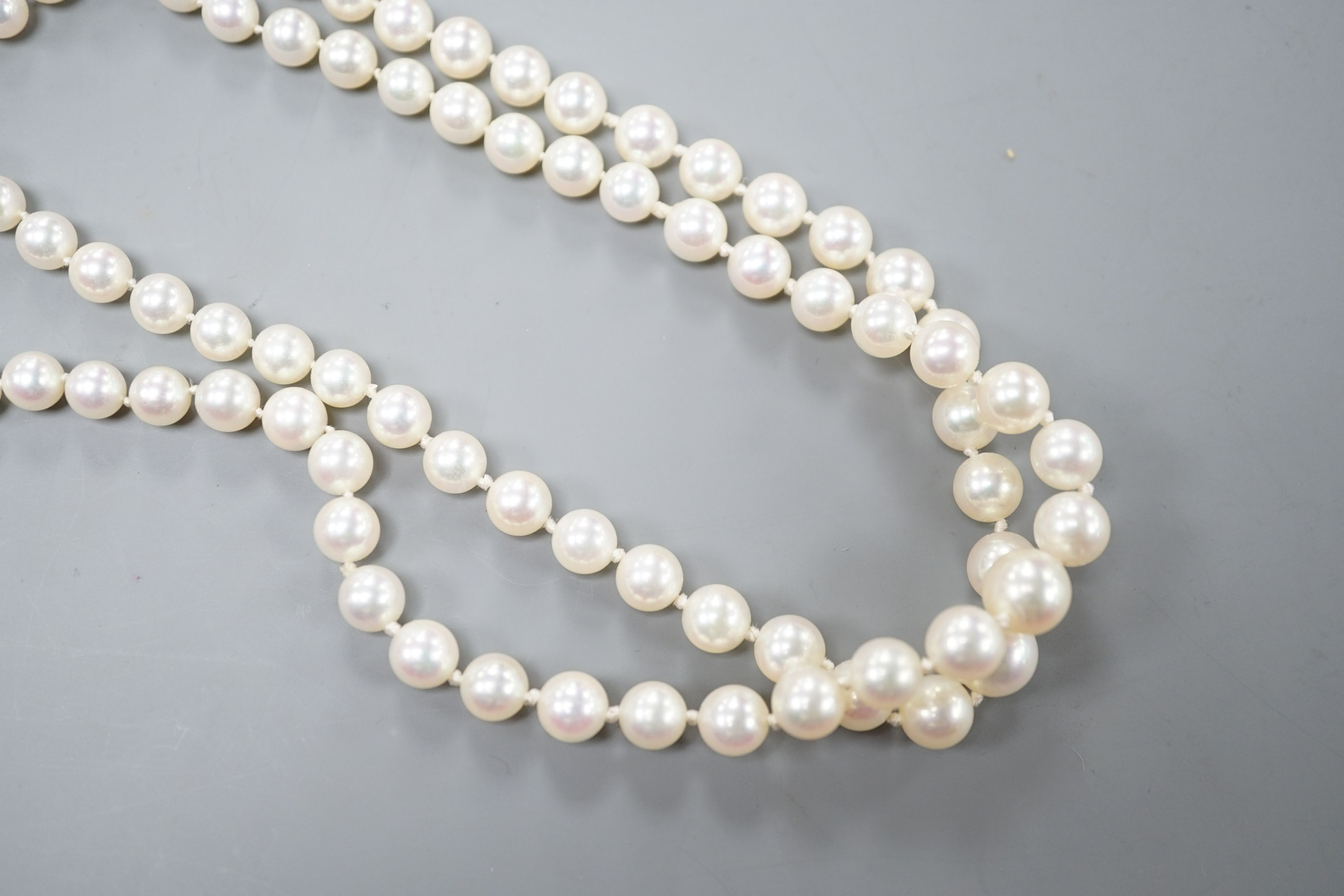 A modern double strand graduated cultured pearl necklace, with amethyst and cultured pearl cluster set 9ct clasp, 42cm.